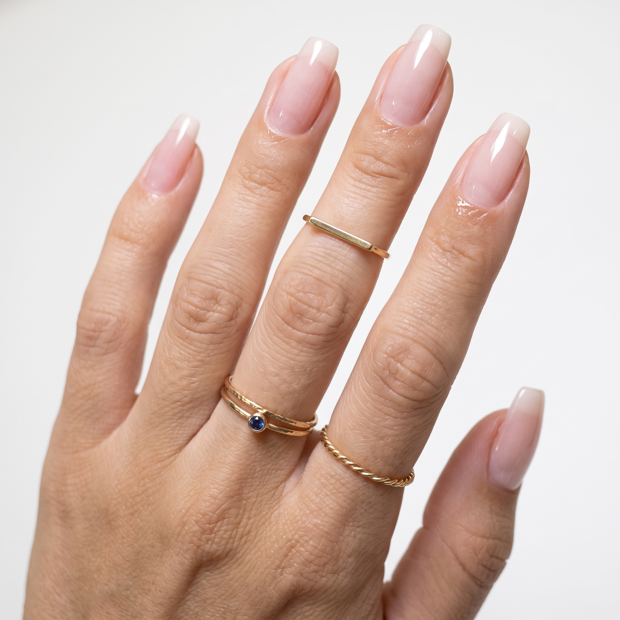 Candy pink gel nails on deep skin tone with a glossy finish