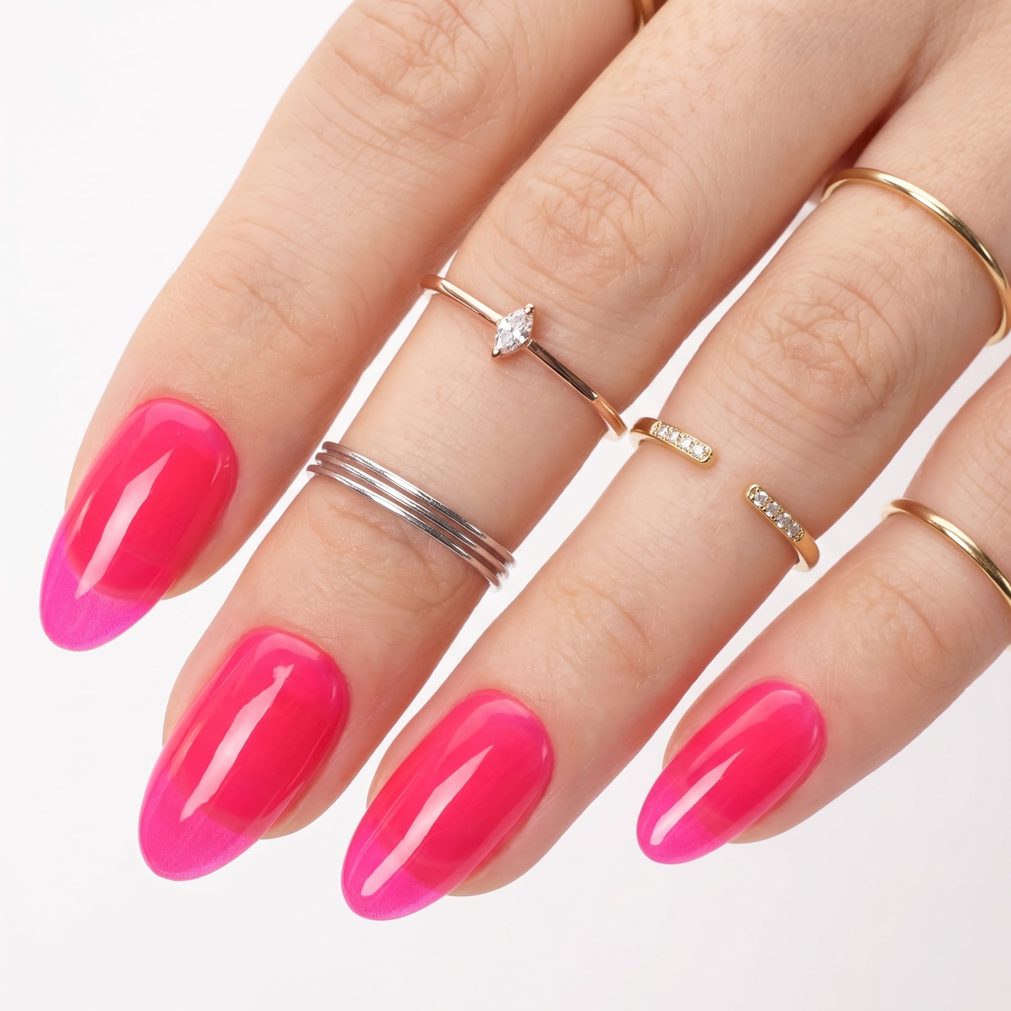 Bright hot pink gel polish on long almond-shaped nails
