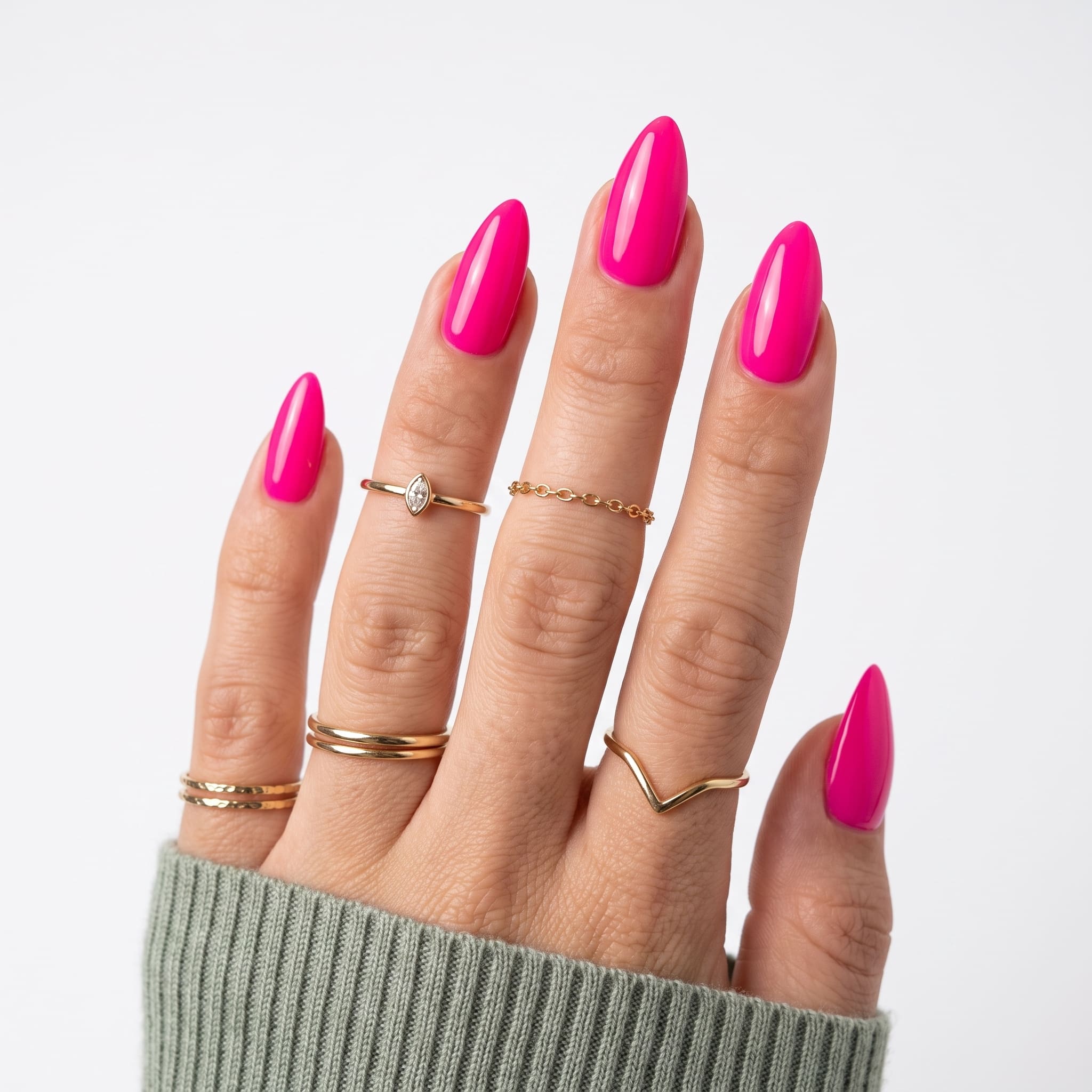 Hot pink gel almond nails with a lavender sweater sleeve