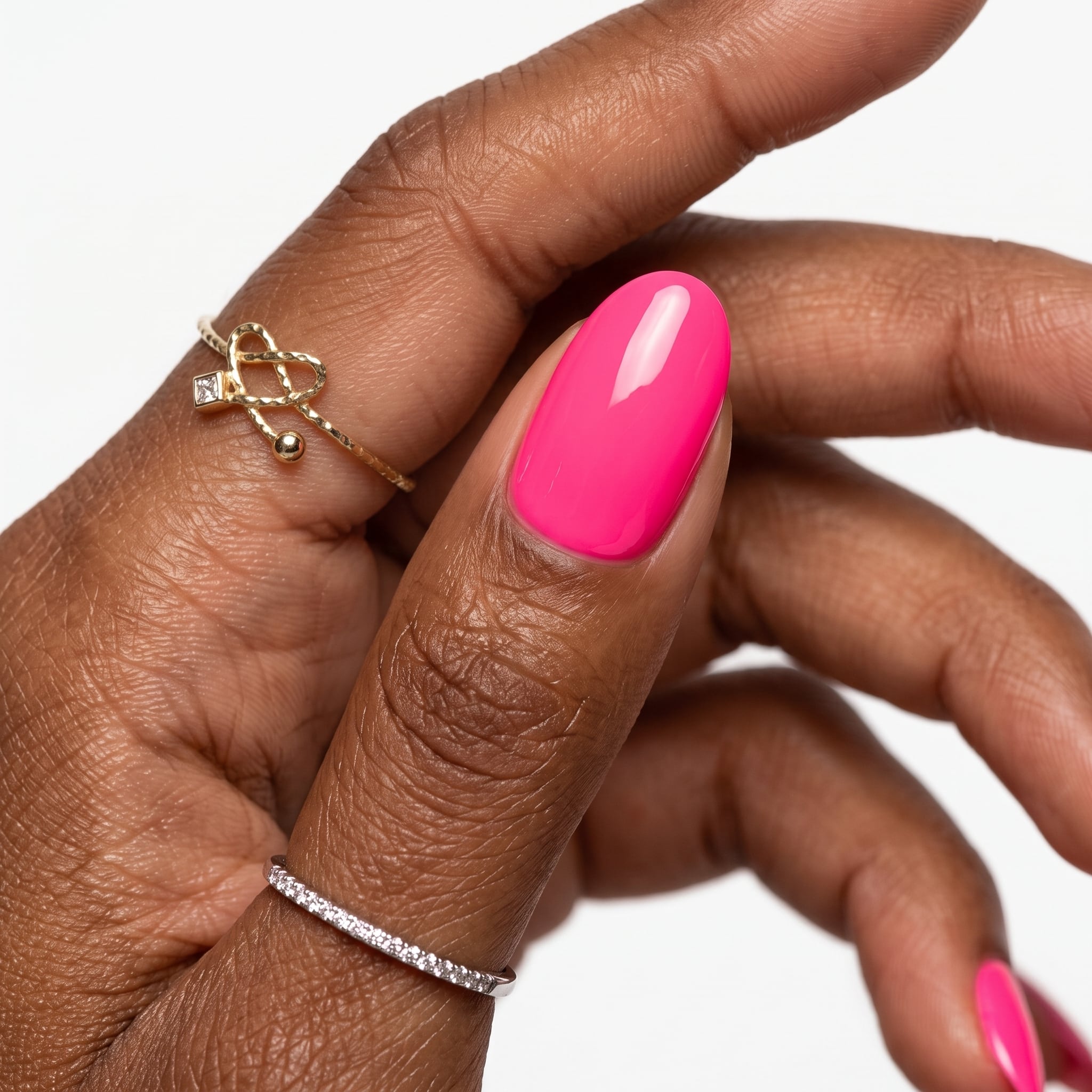 Glossy hot pink gel square nails on a light-skinned hand