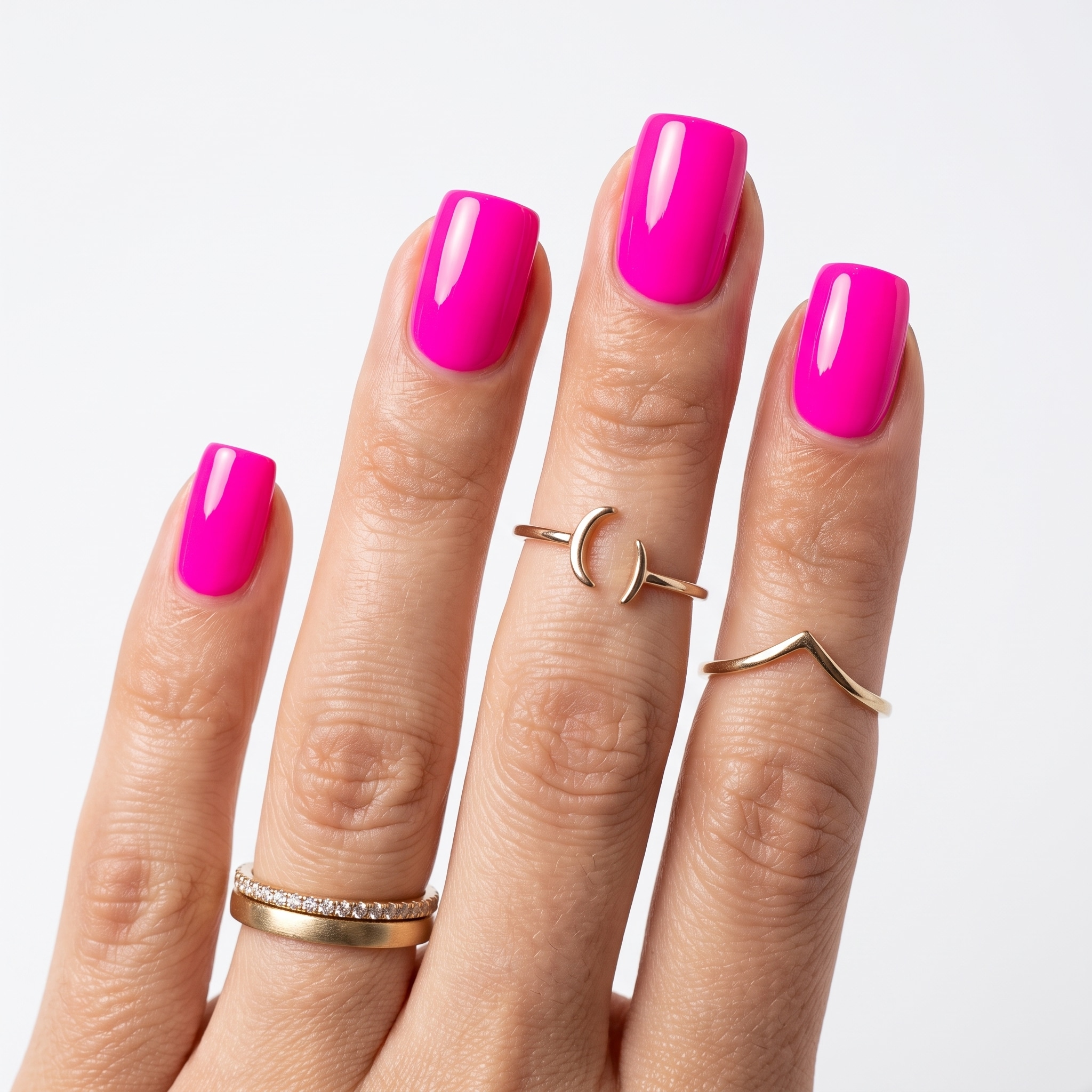Glossy hot pink almond nails paired with a neutral sweater