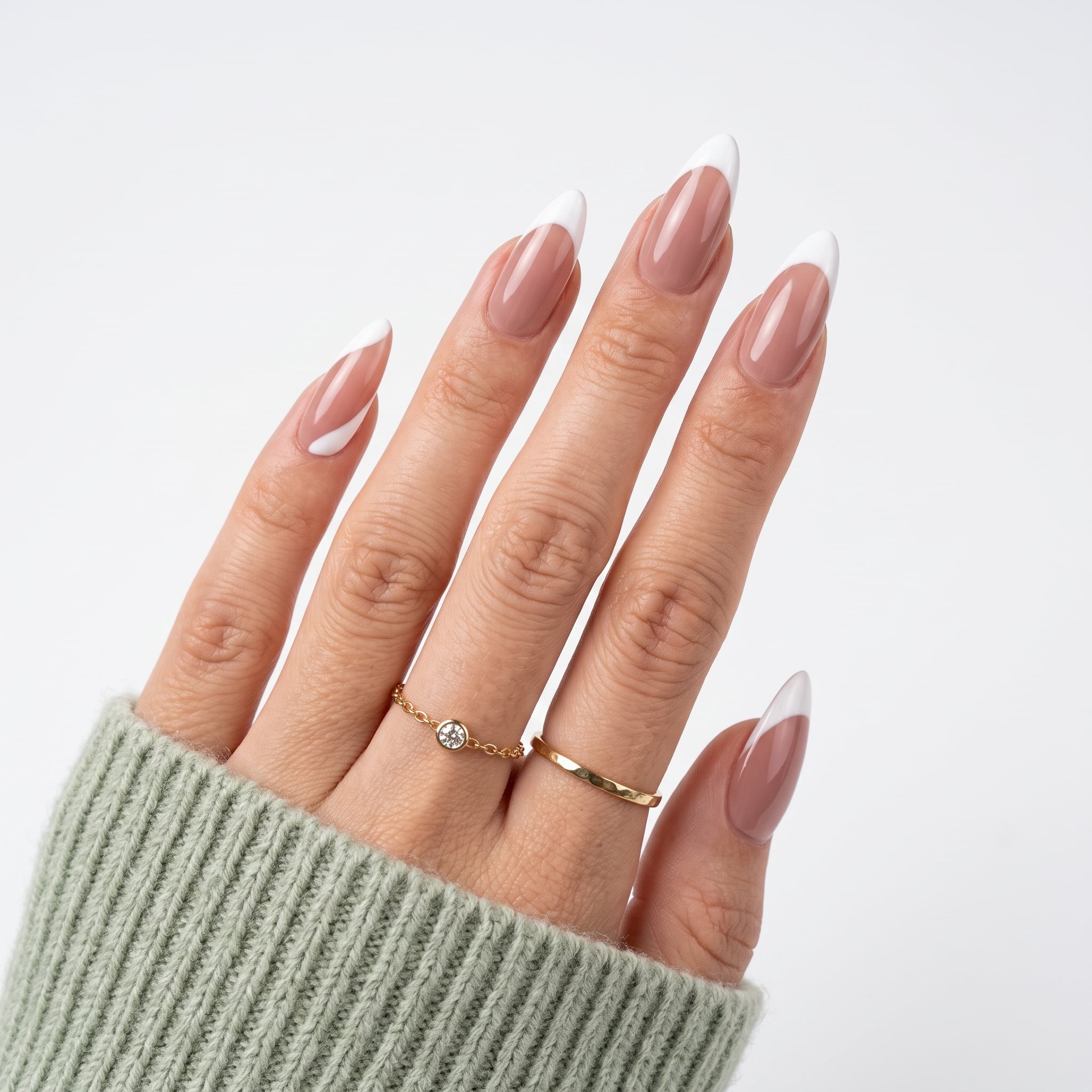 Soft pink manicure with white swirl nail art on almond nails