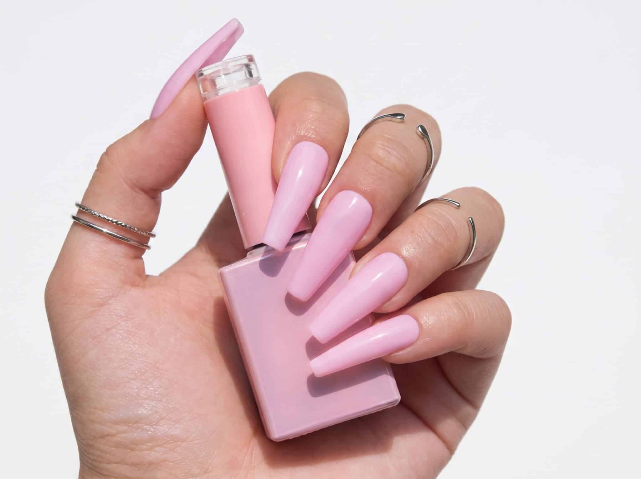 Glossy blush pink manicure on almond nails with a soft salon finish