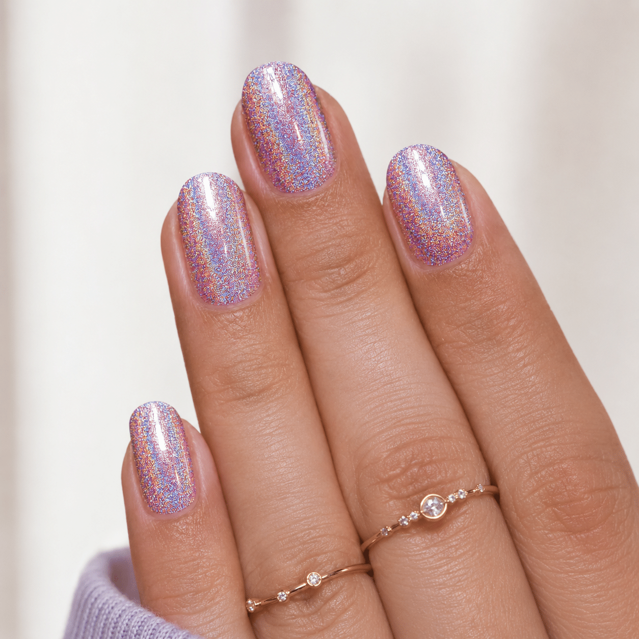 Blush pink holographic sparkle nails with a soft glossy finish