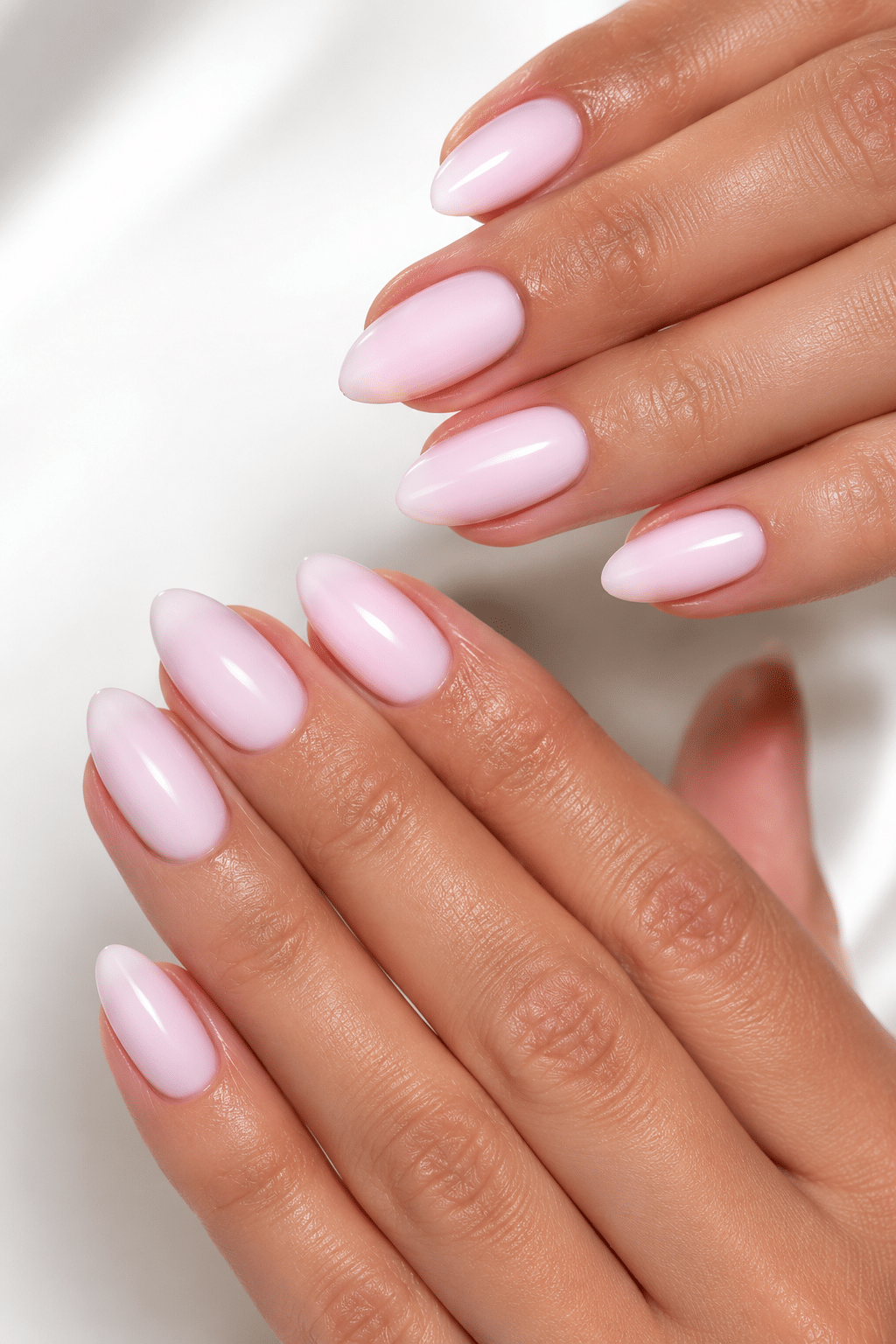 Glossy milky pink long nails with a soft creamy polish finish
