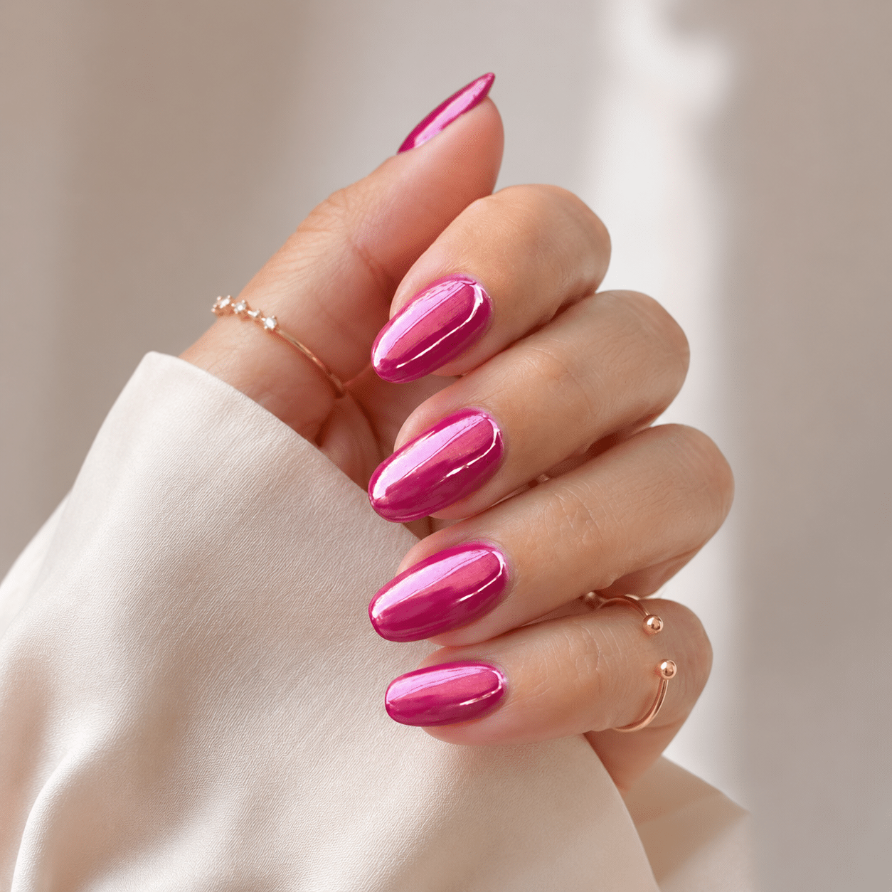 Hot pink chrome nails with a bright metallic shine