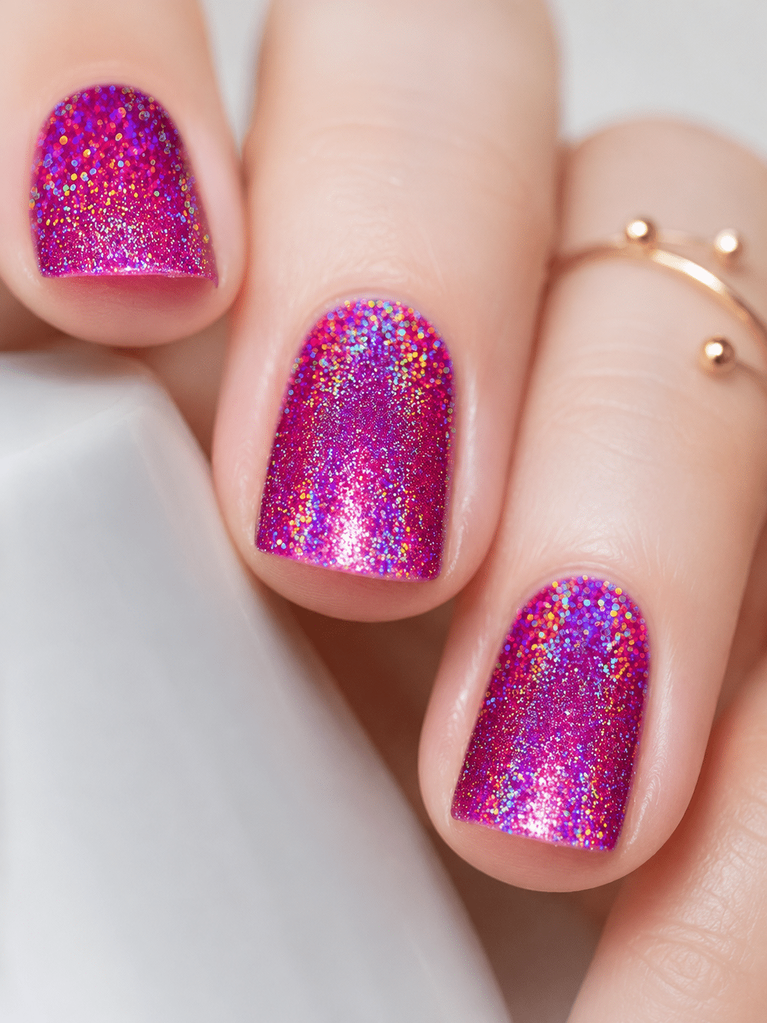 Pink holographic nail polish with a bold hot pink rainbow shimmer finish