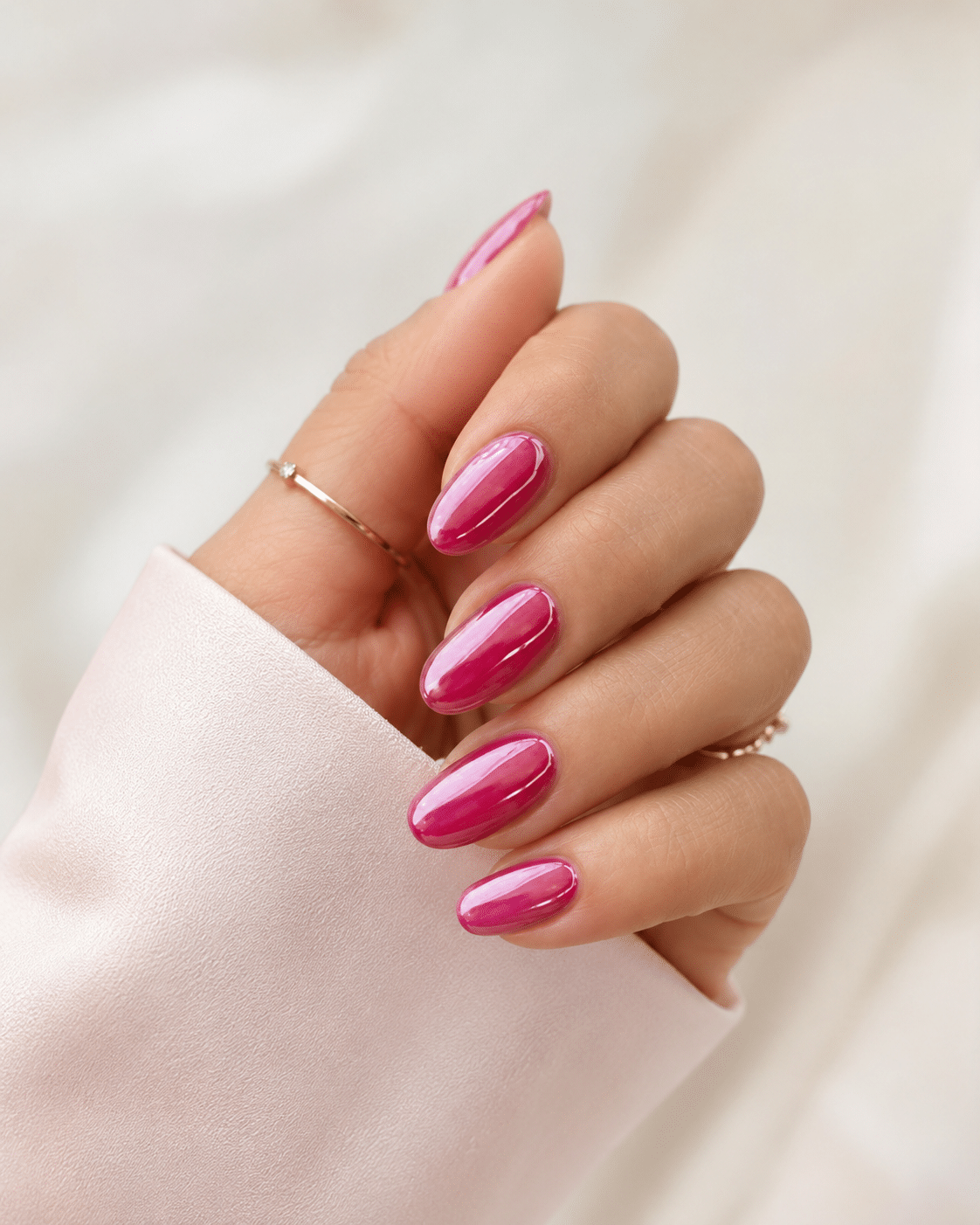 Mirror candy pink chrome nails with a glossy metallic finish