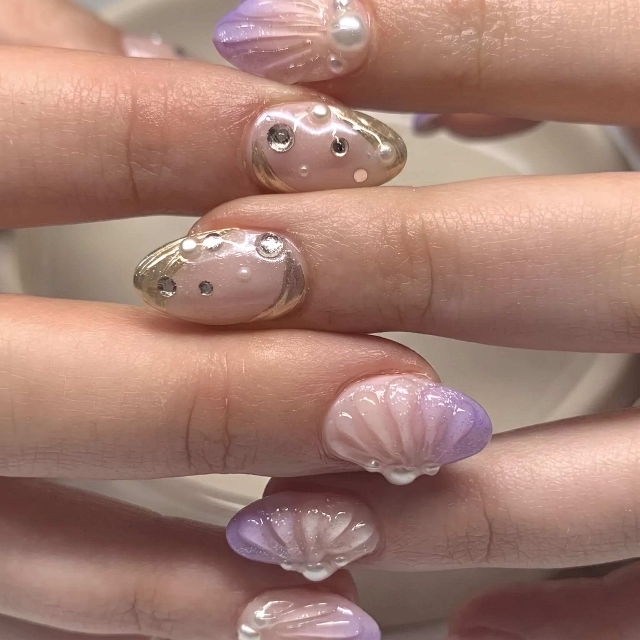 pearl jam manicure with iridescent shell texture and glossy ocean shine
