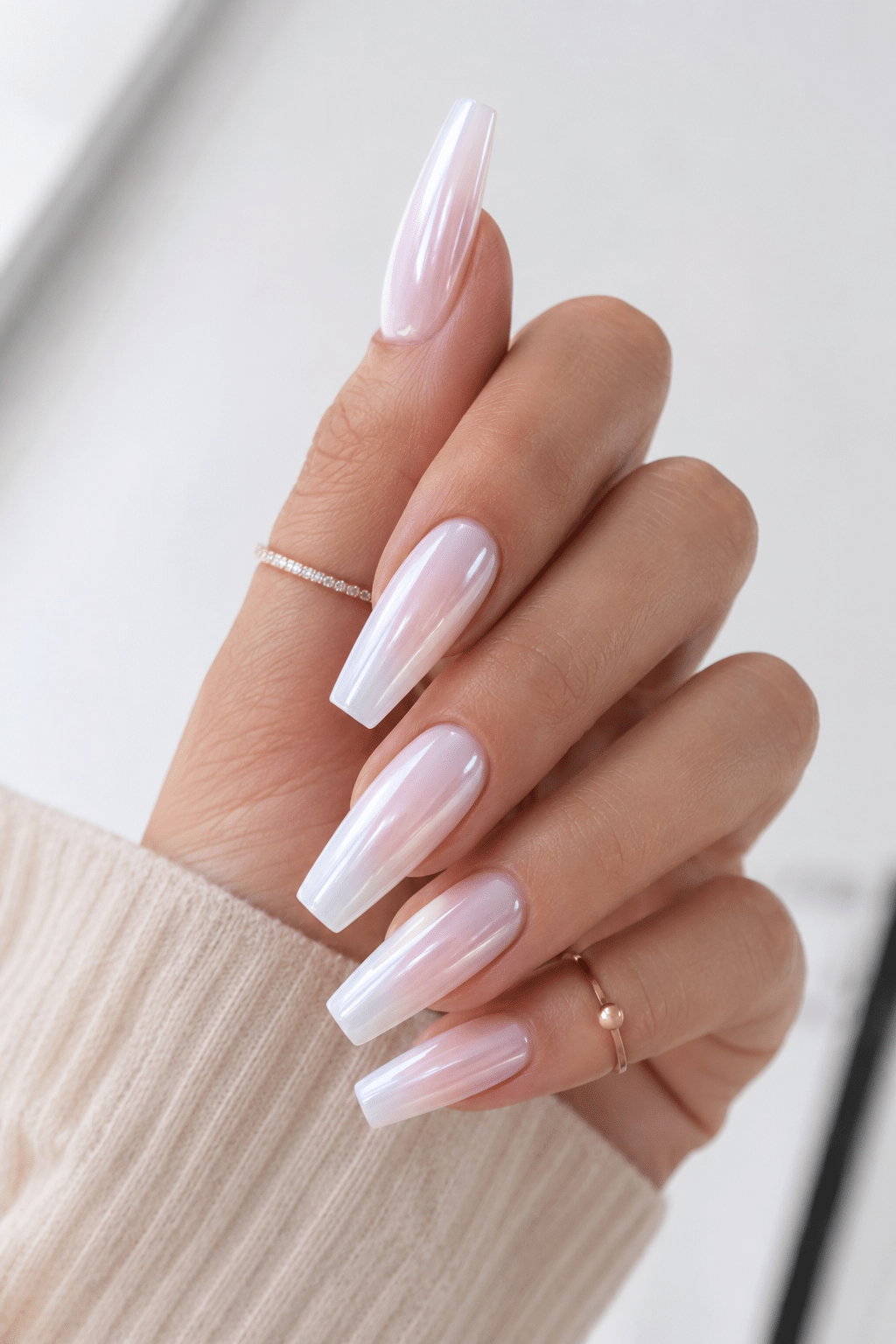 pearl white nail polish on long stiletto nails with luminous shimmer