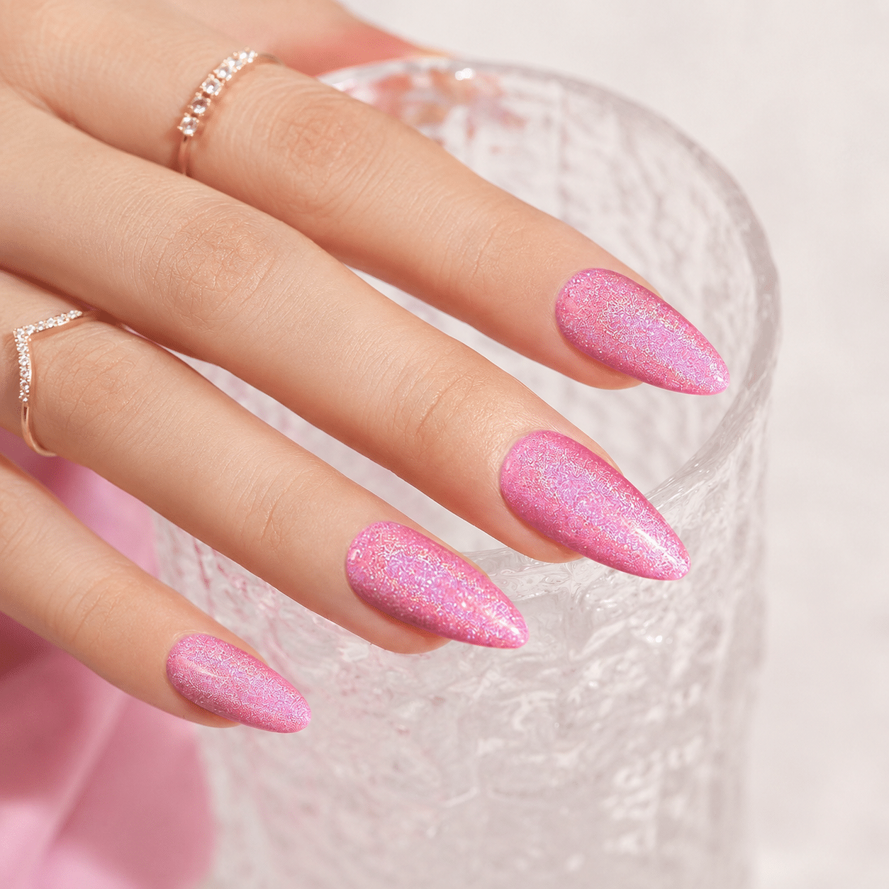 Pink holo glitter almond nails with a sparkling glossy finish