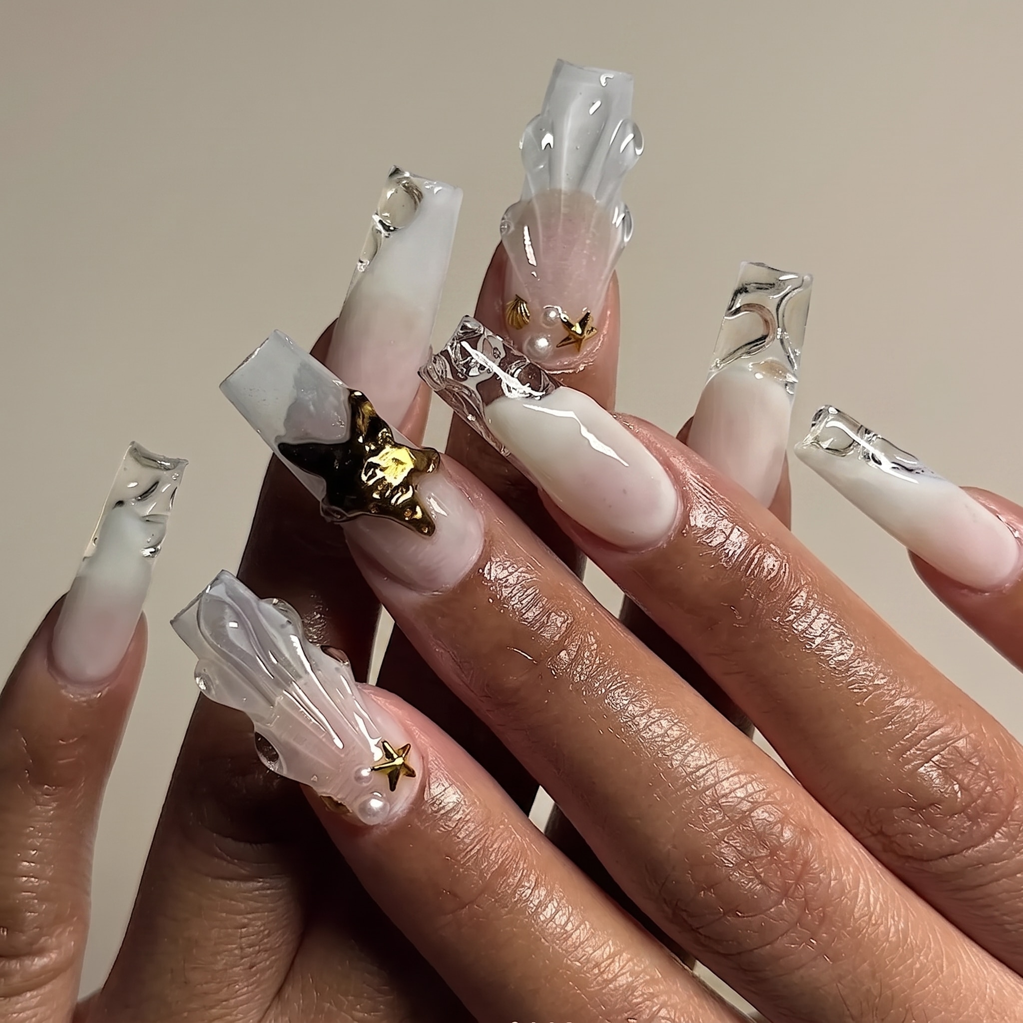 powder blue shell manicure with pearl accents and glossy summer finish