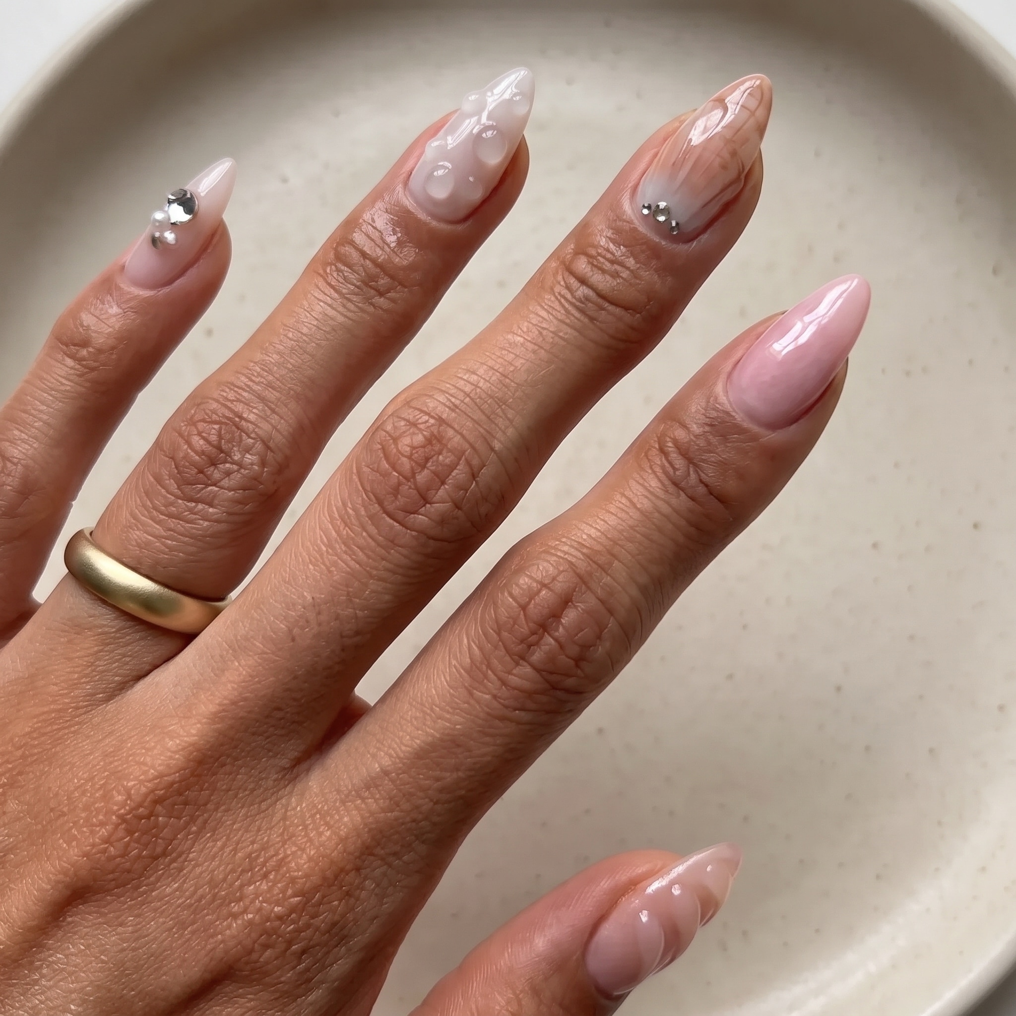 ride the wave manicure with soft coastal shimmer and shell accent nail