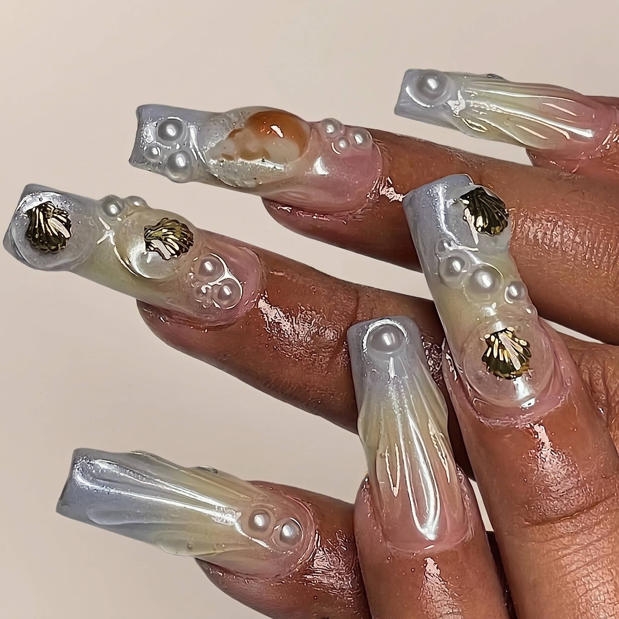 white chrome manicure with subtle shell glow and glossy almond shape