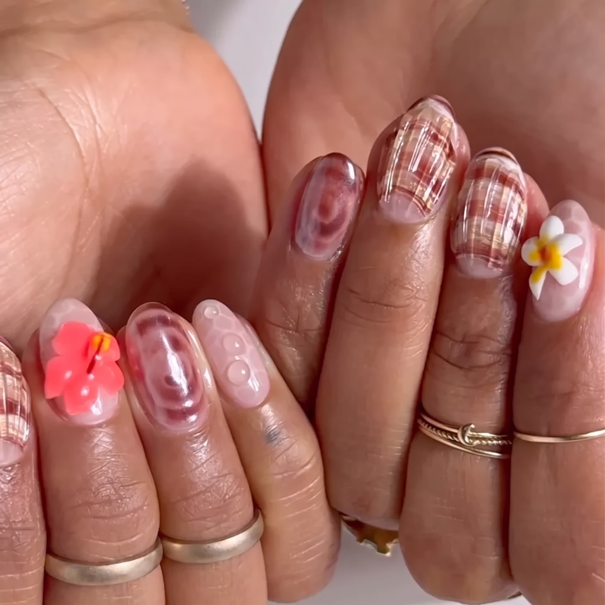 siren tip manicure with pink iridescent shell details and pearl accents