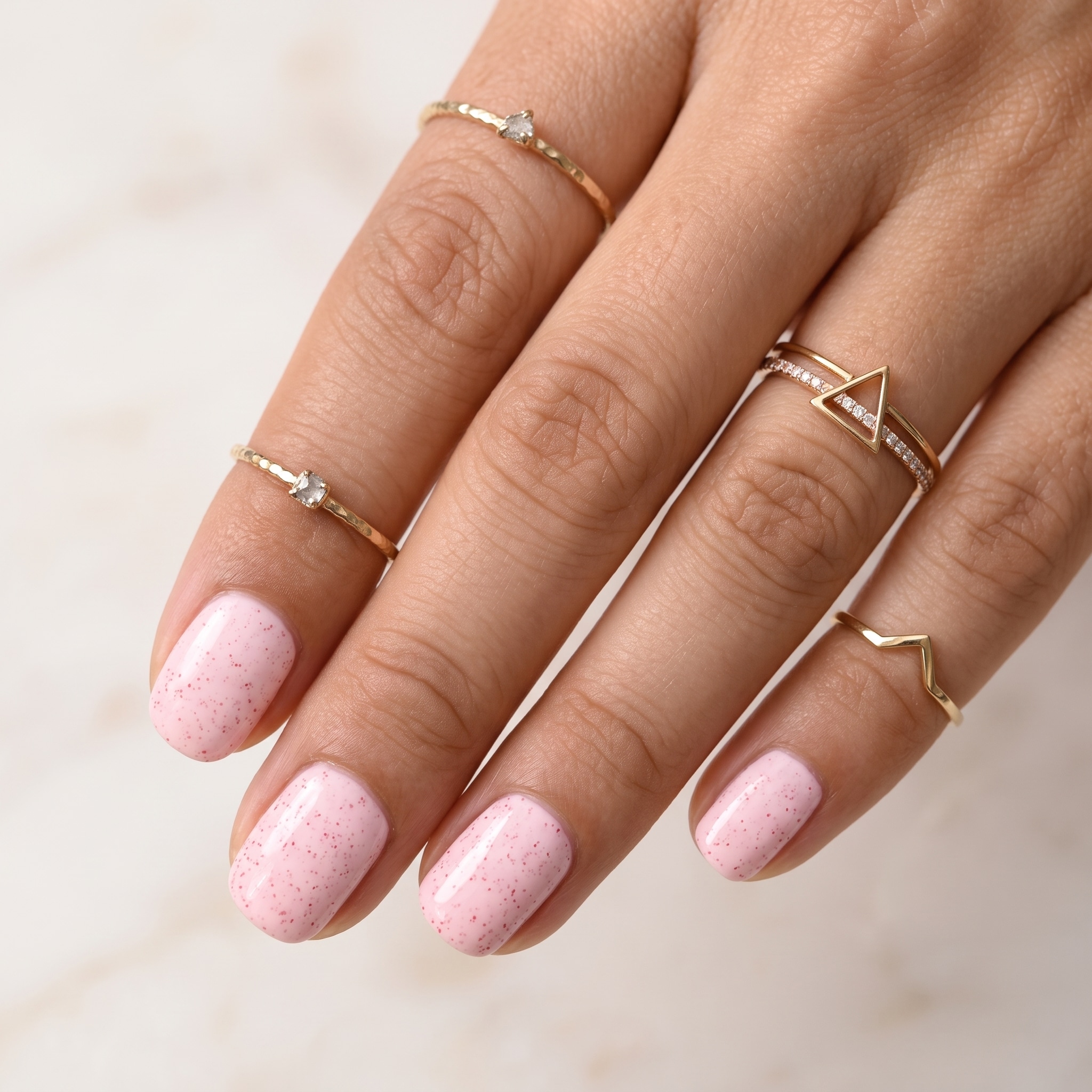 Soft glossy baby pink nails with a clean feminine finish