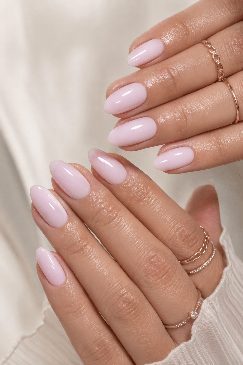 Speckled milky pink nail polish with a soft glossy manicure look