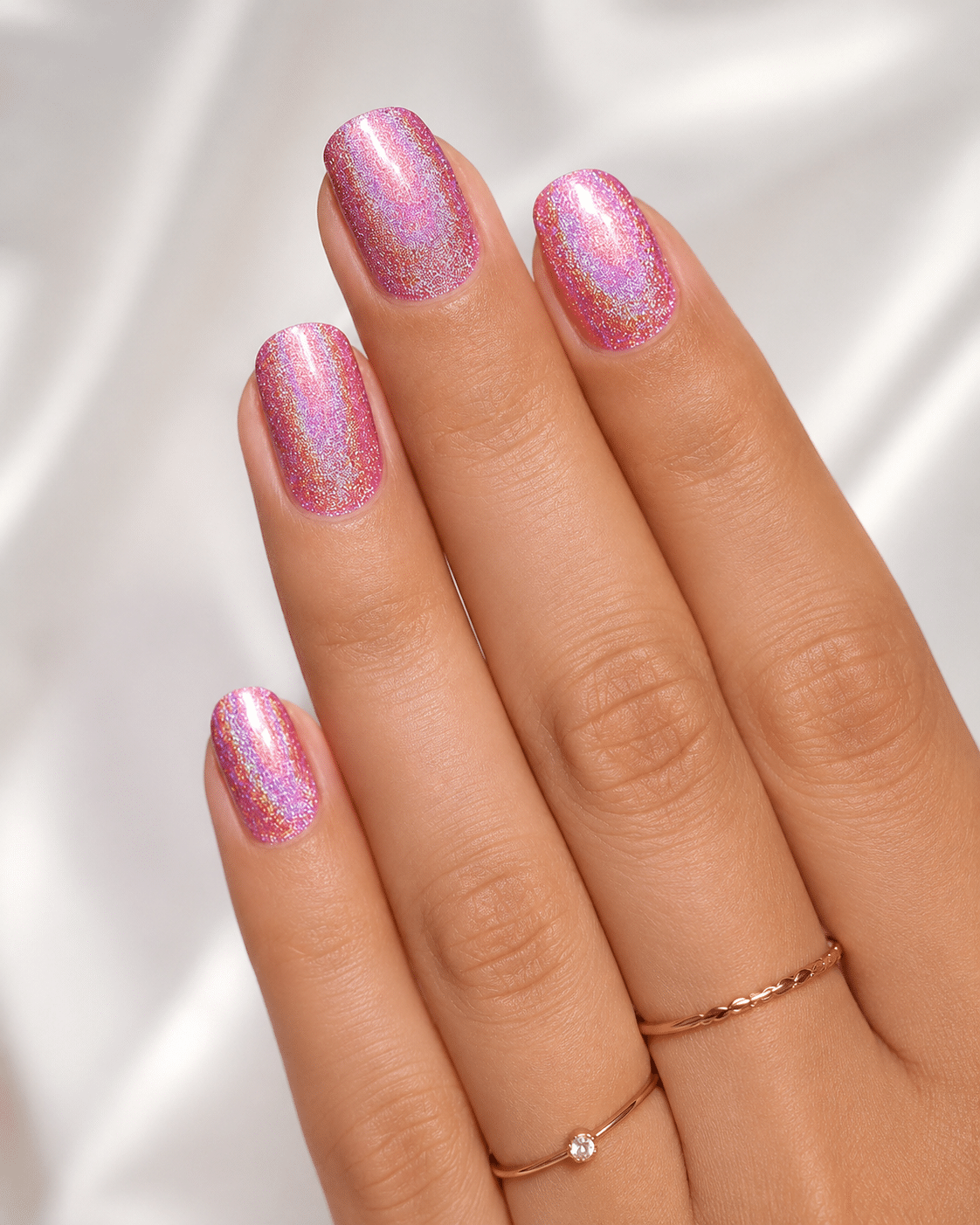 Sunlit pink holographic nails with a delicate shimmer finish