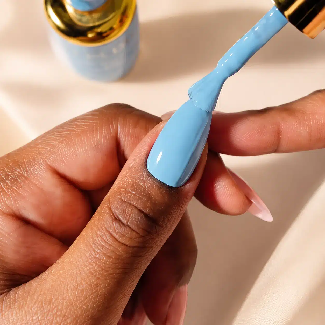 Milky Blue Nail Polish: 10 Soft Manicure Ideas to Try 2 Applying milky blue nail polish with a flat brush