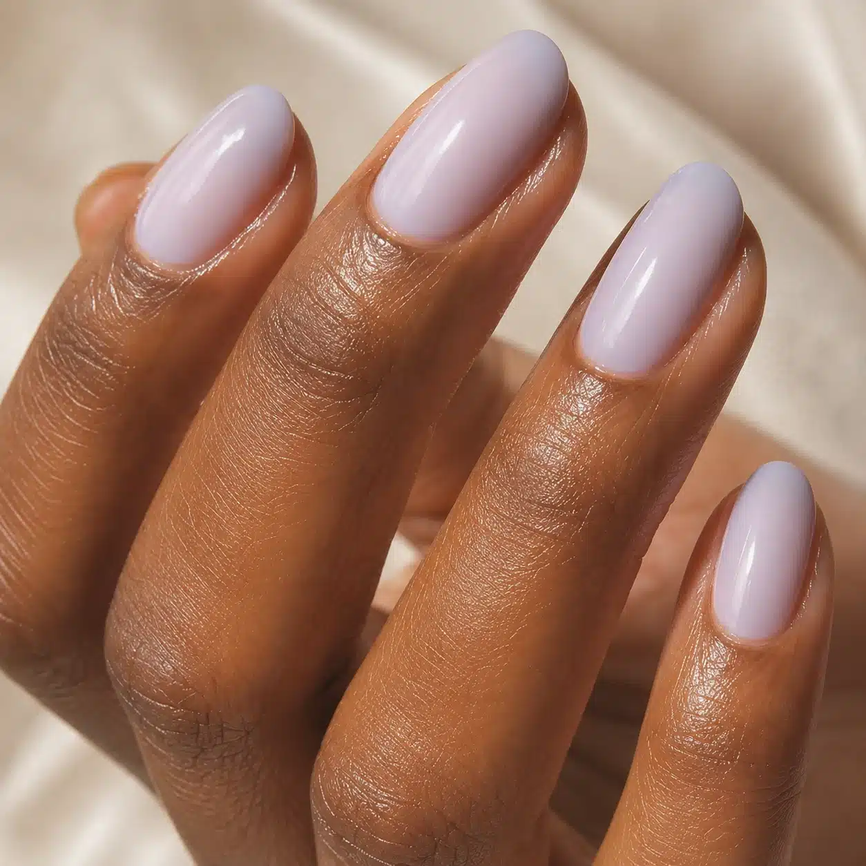 Milky Lavender Nail Polish: Soft Lavender Milk Nails to Try 4 Milky lavender nail polish on deep skin with soft shine