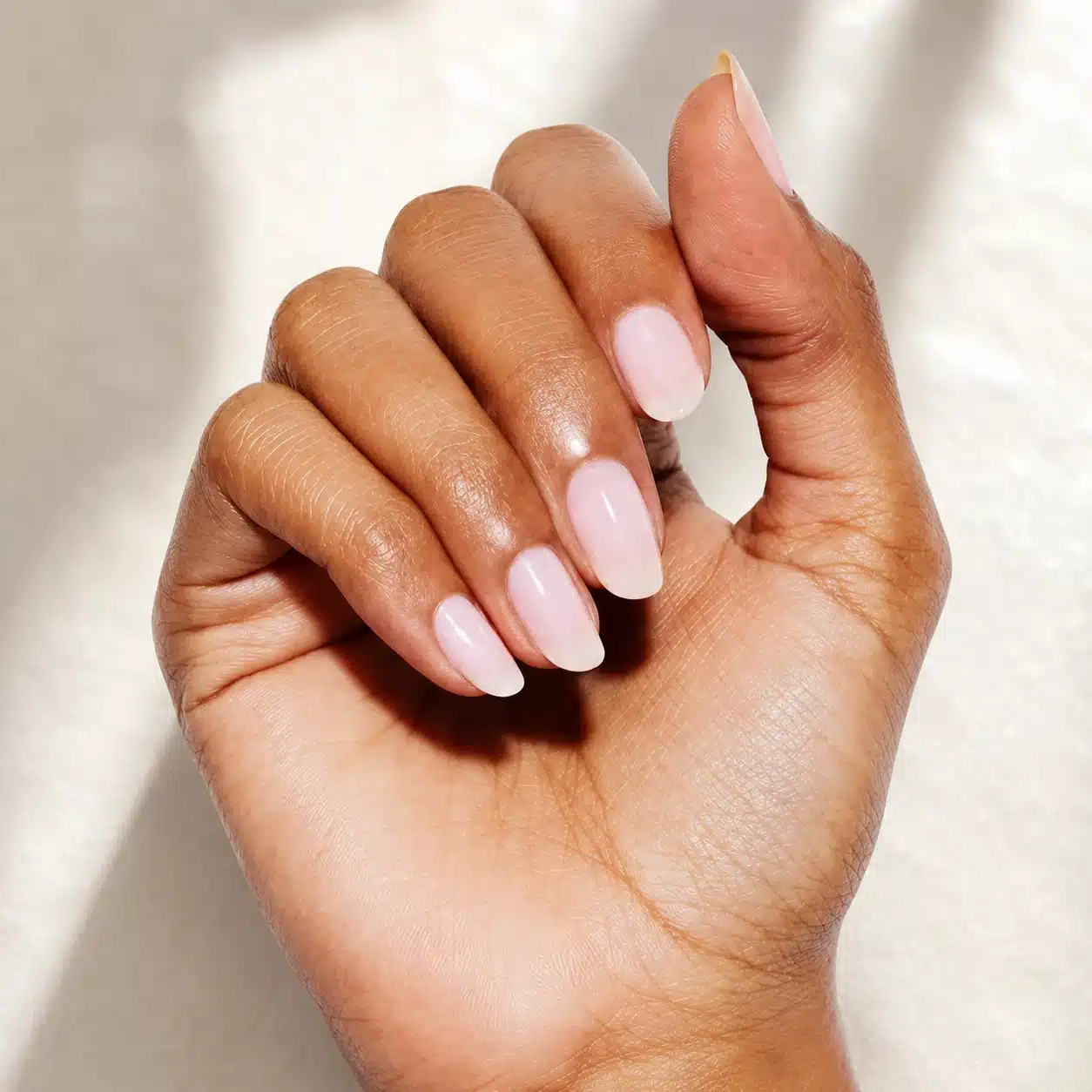 Milky Pink Gel Nail Polish: Soft Jelly Pink Gel Manicure Guide 7 Milky pink gel nails on deep skin with soft shine
