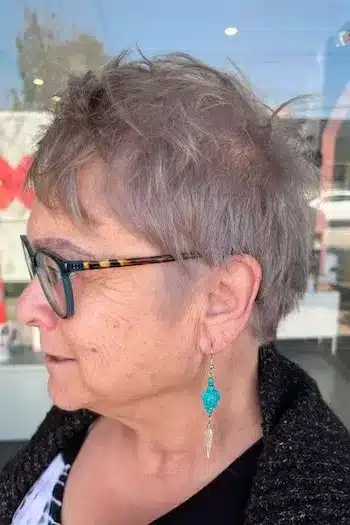 Pixie Haircuts for Women Over 60 With Fine Hair - Wispy Gray Pixie With Choppy Crown Haircut, side view.