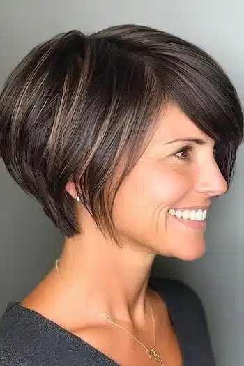 Pixie bob with side-swept bangs on a smiling woman