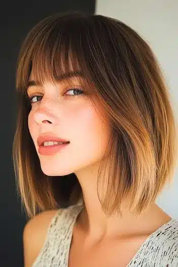 Ombre long bob with bangs on a smiling woman