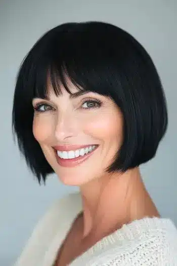 Jaw-length bob with bangs on a smiling woman