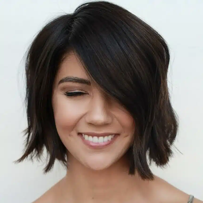 Side-swept short bob with asymmetrical lines, among the 35 short brown hairstyles you'll be seeing everywhere
