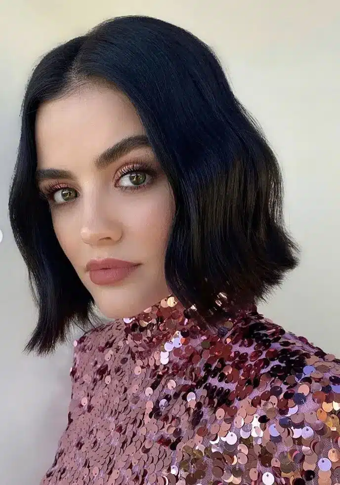 Model wearing a blunt chin bob, one of the 35 short brown hairstyles you'll be seeing everywhere