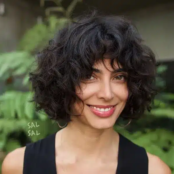 Curly chin bob with defined coils, part of the 35 short brown hairstyles you'll be seeing everywhere
