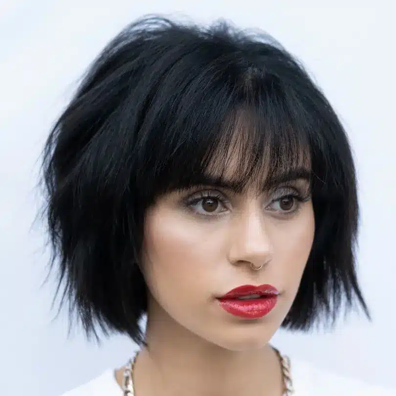 Fringed chin bob with straight bangs, one of the 35 short brown hairstyles you'll be seeing everywhere