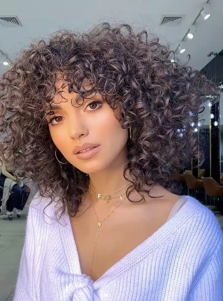 Curly shoulder shag with feathered layers, part of the 35 short brown hairstyles you'll be seeing everywhere
