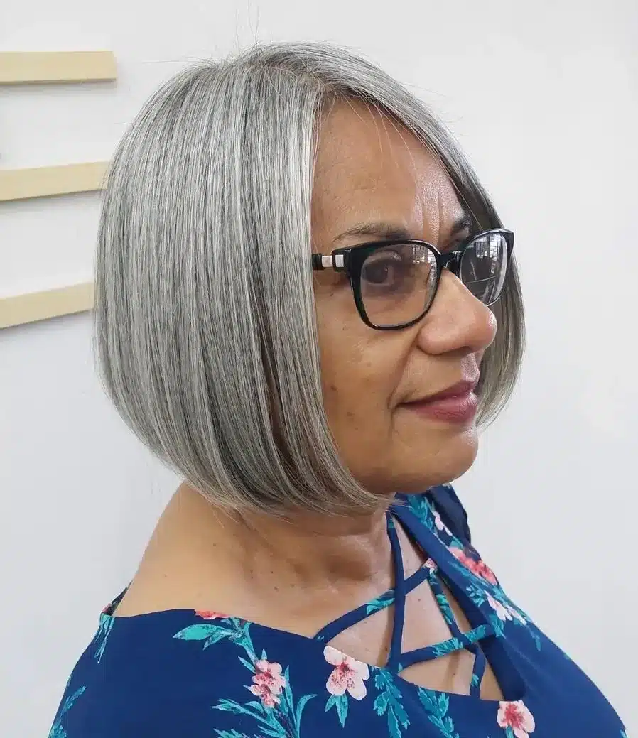 Sleek gray chin length bob for older women with glasses