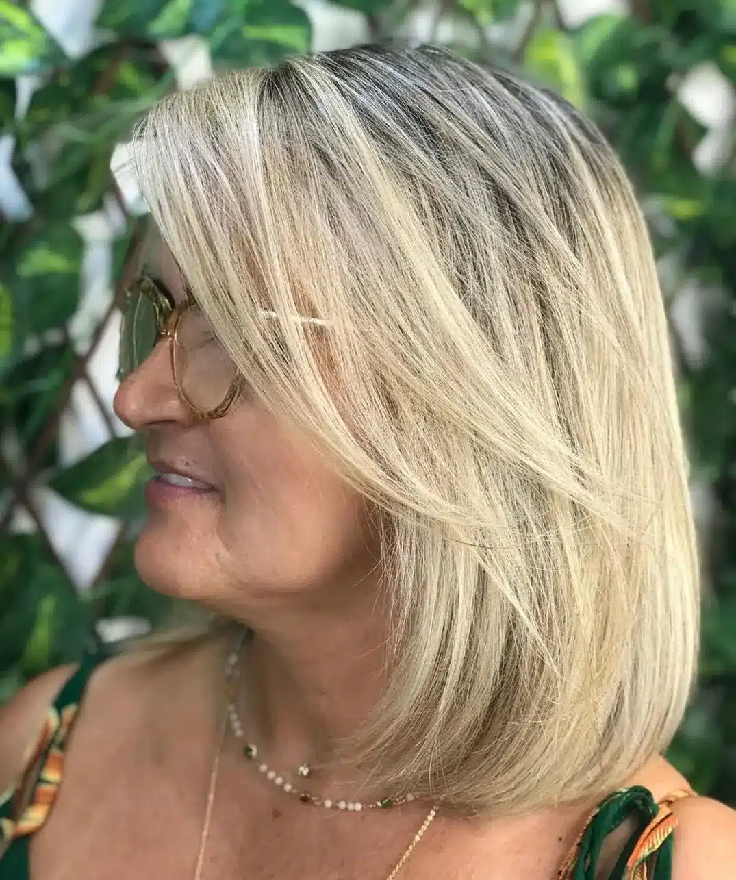 Long bob with deep side part and bangs for over 50