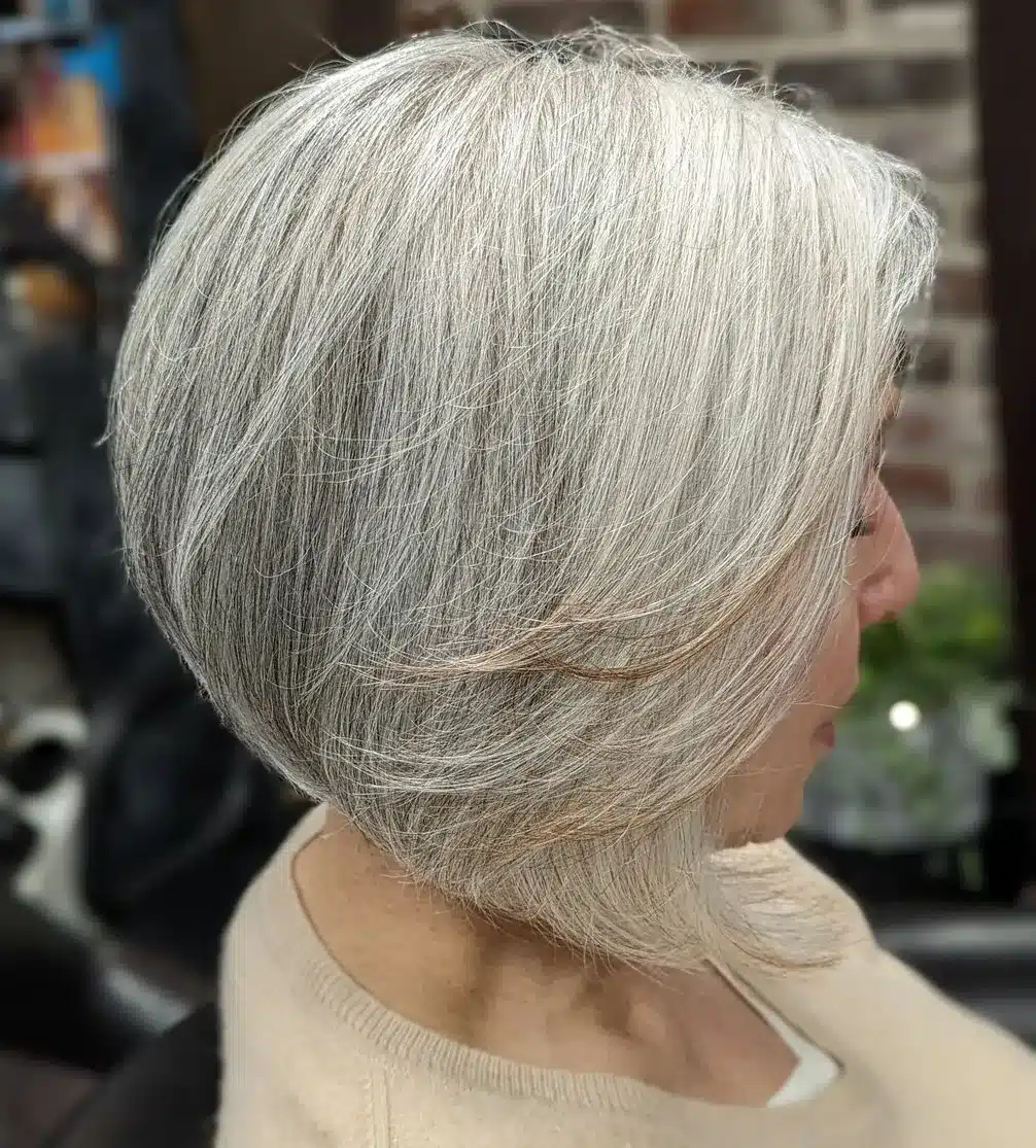 Rounded bob with feathery layers on naturally gray hair